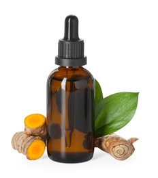 Photo of Bottle of turmeric essential oil, raw roots and leaves isolated on white