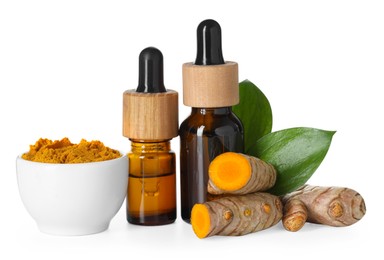 Photo of Bottles of turmeric essential oil, powder, raw roots and leaves isolated on white