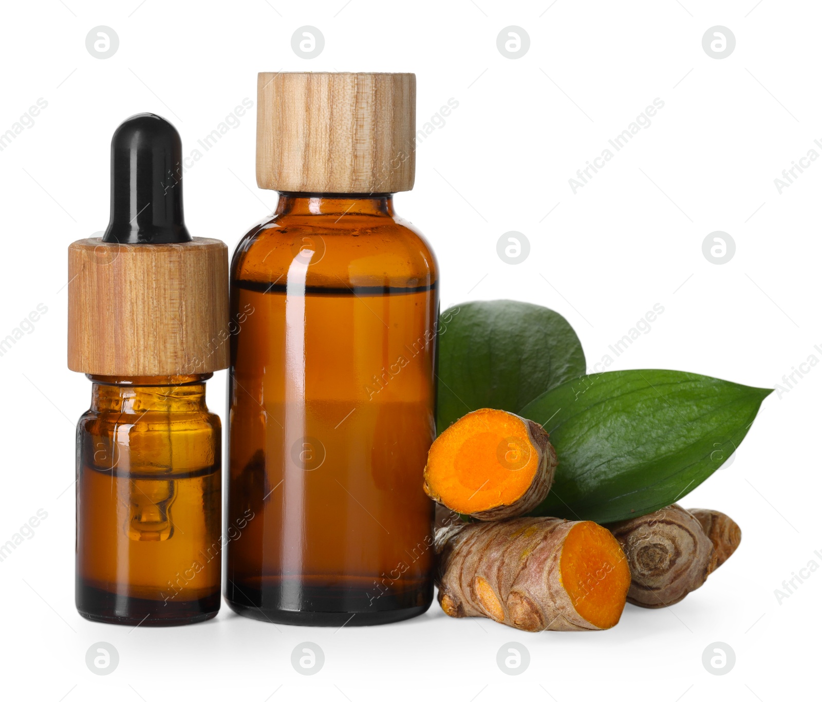 Photo of Bottles of turmeric essential oil, raw roots and leaves isolated on white