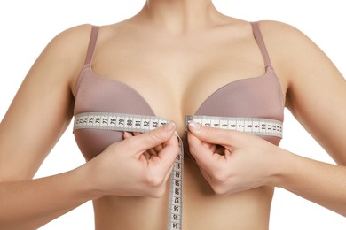 Photo of Woman in beautiful bra measuring breast circumference on white background, closeup