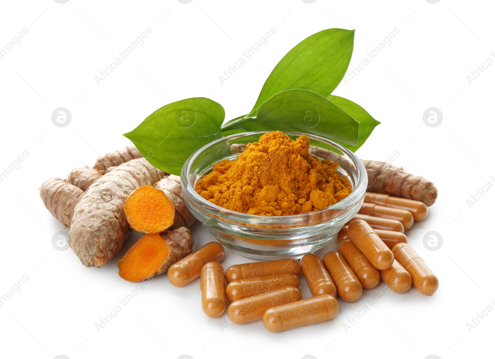 Turmeric powder in bowl, roots and capsules isolated on white Photo of Turmeric powder in bowl, roots and capsules isolated on white