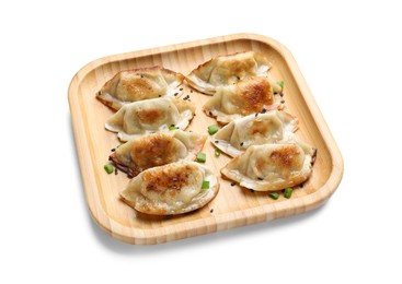 Photo of Delicious fried gyoza dumplings with green onions and sesame seeds isolated on white