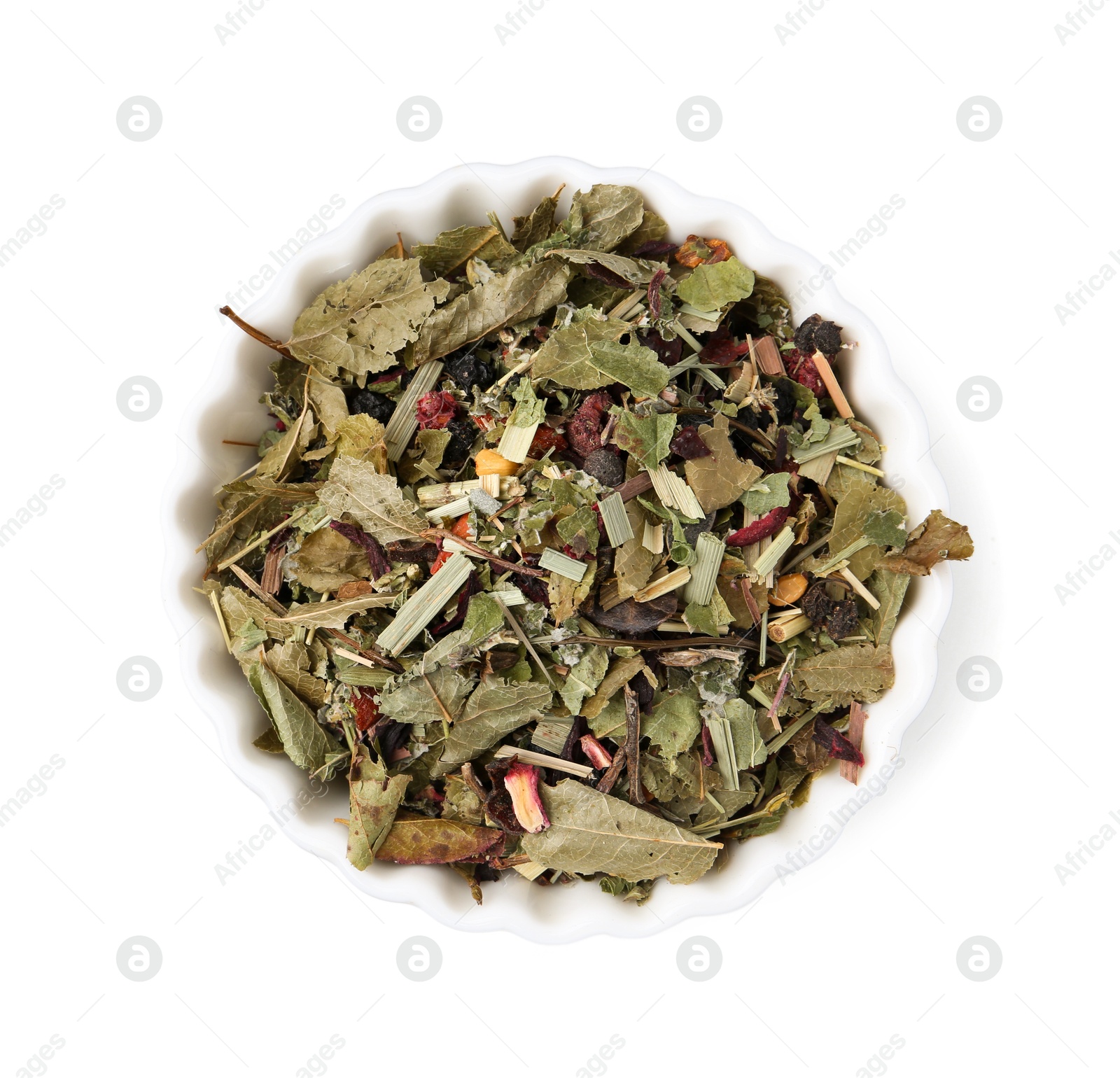 Photo of Dry herbal tea brew in bowl isolated on white, top view