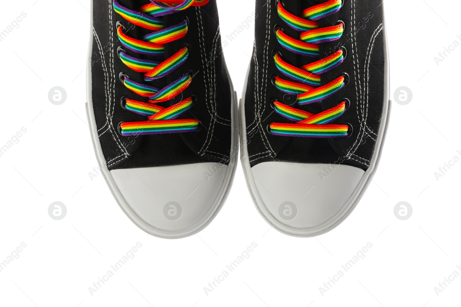 Photo of Black shoes with bright rainbow laces on white background, top view. LGBT concept