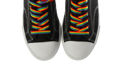 Photo of Black shoes with bright rainbow laces on white background, top view. LGBT concept