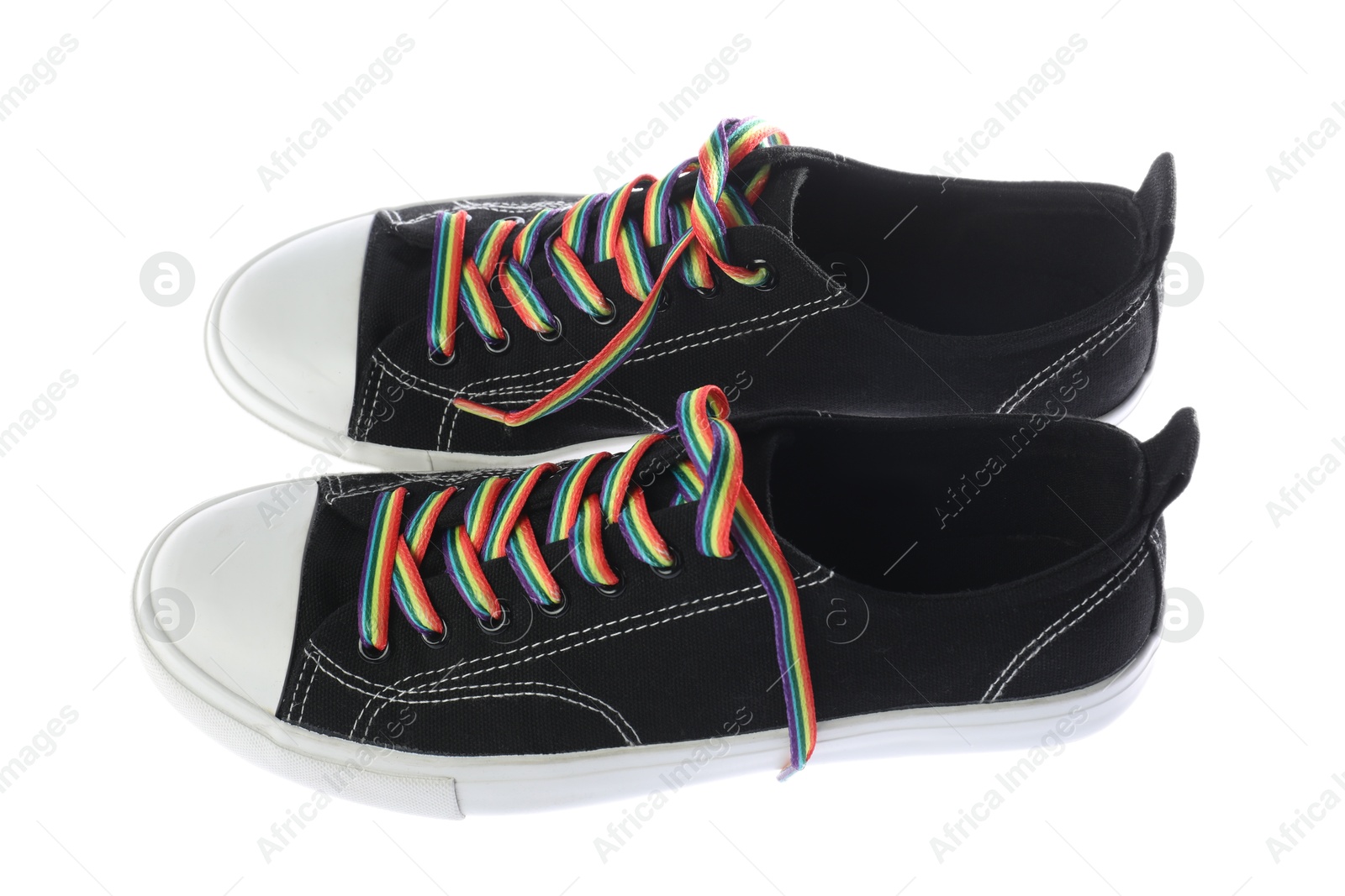 Photo of Black shoes with bright rainbow laces on white background. LGBT concept