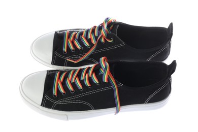 Photo of Black shoes with bright rainbow laces on white background. LGBT concept