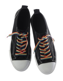 Photo of Black shoes with bright rainbow laces on white background, top view. LGBT concept