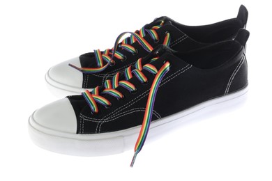 Photo of Black shoes with bright rainbow laces on white background. LGBT concept