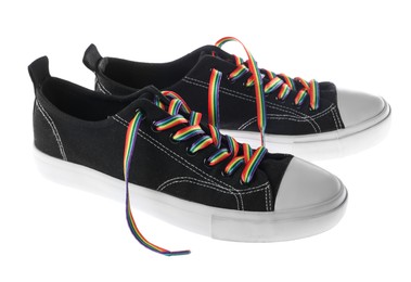 Photo of Black shoes with bright rainbow laces on white background. LGBT concept