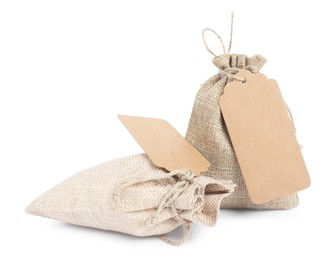 Photo of Burlap bags with tags isolated on white