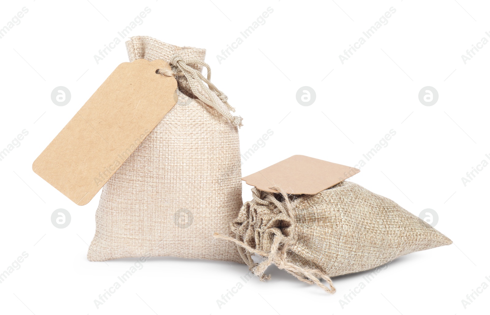 Photo of Burlap bags with tags isolated on white