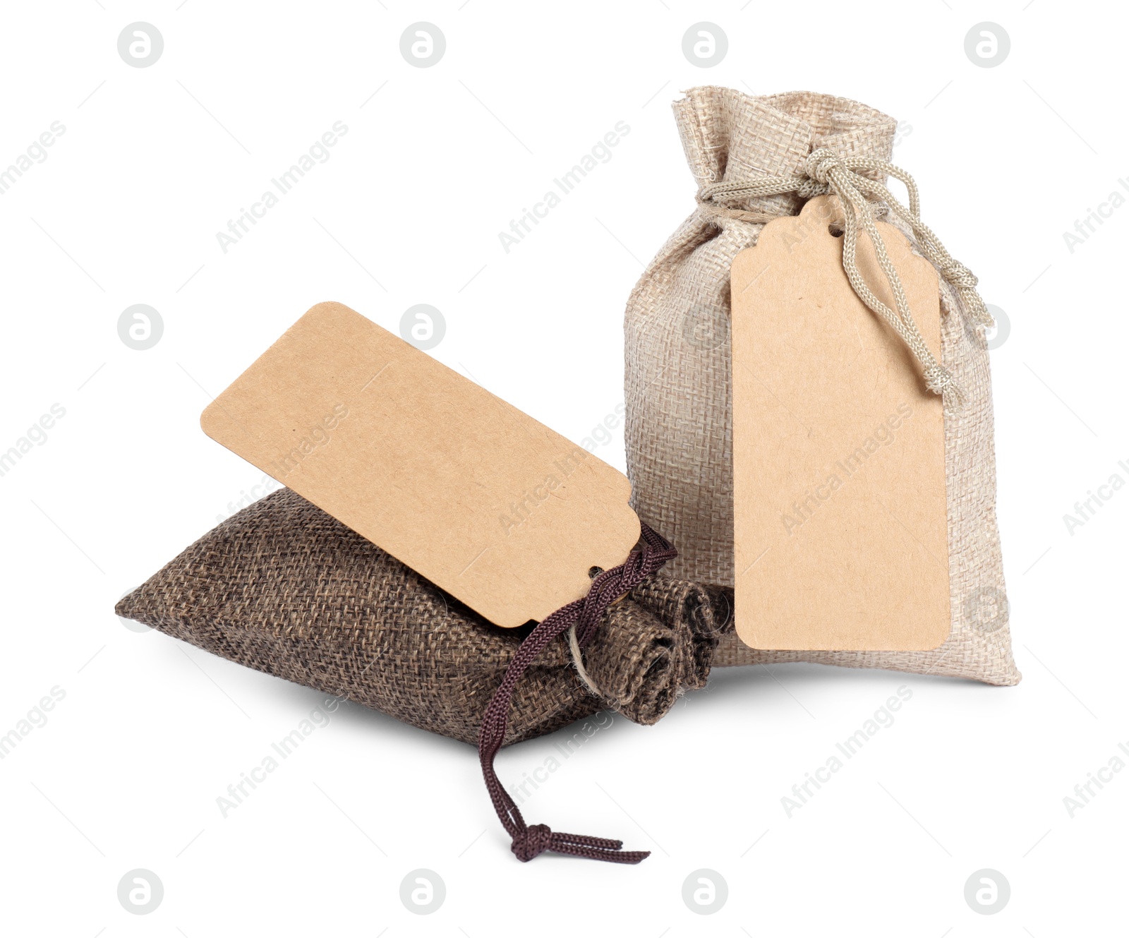 Photo of Burlap bags with tags isolated on white