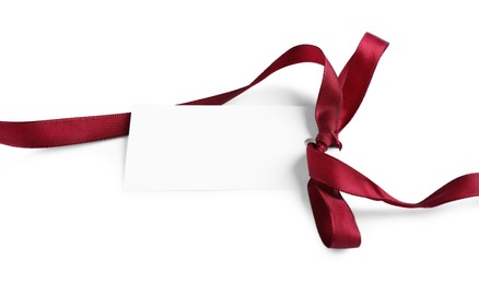 Photo of Blank tag with ribbon bow isolated on white