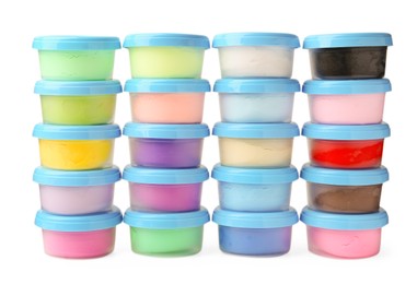 Photo of Different colorful modeling clay in plastic jars isolated on white