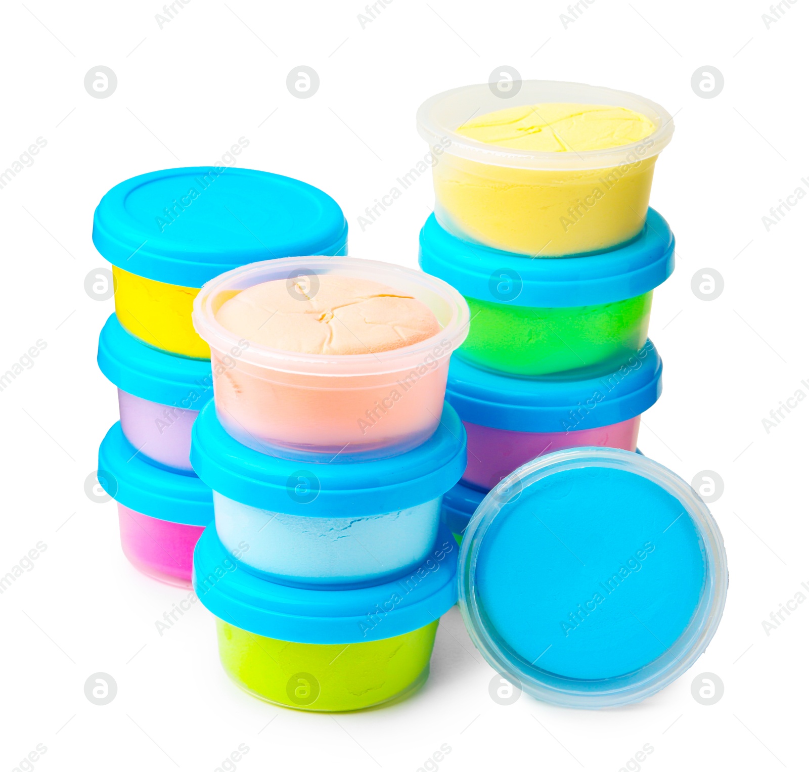 Photo of Different colorful modeling clay in plastic jars isolated on white