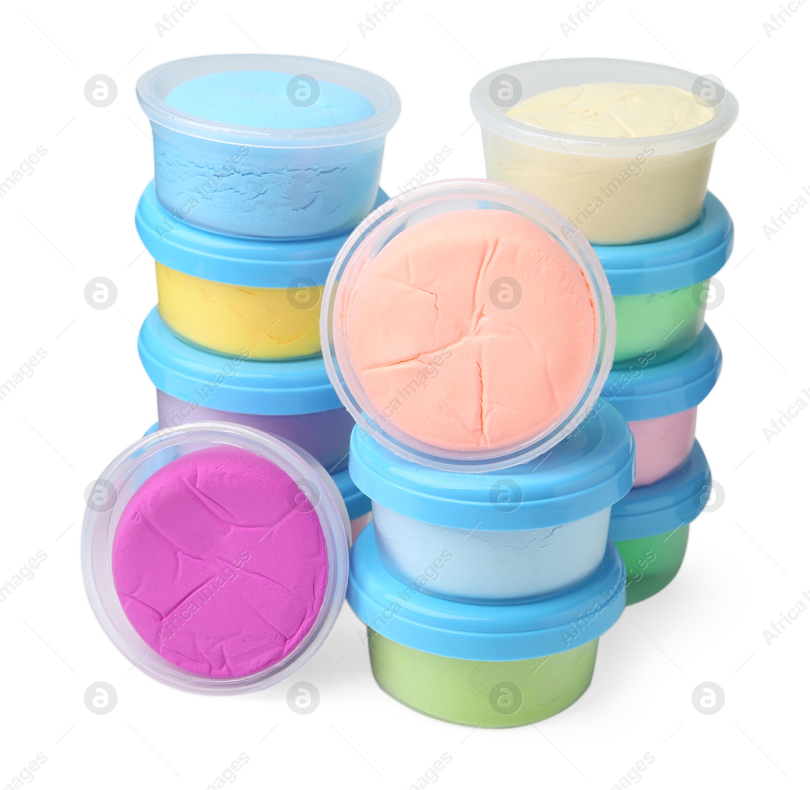 Photo of Different colorful modeling clay in plastic jars isolated on white