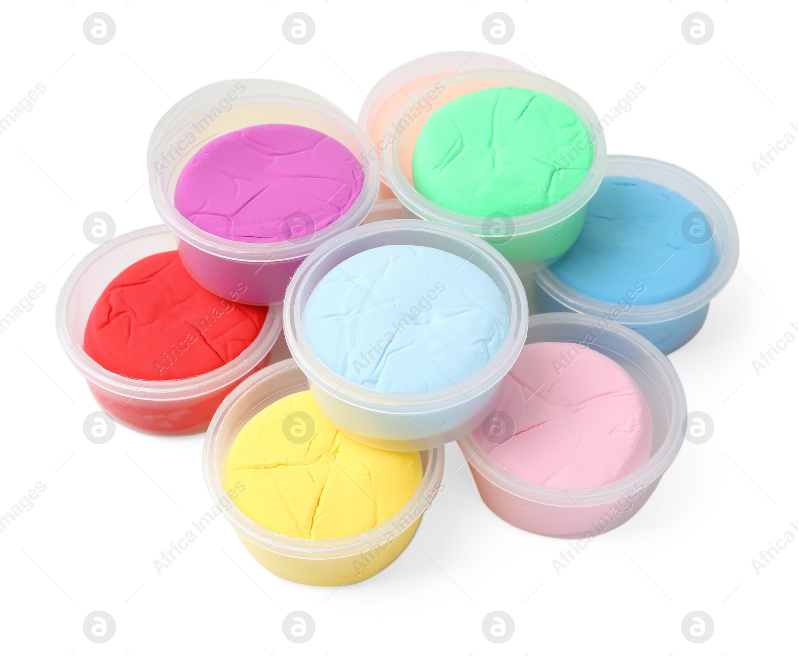 Photo of Different colorful modeling clay in plastic jars isolated on white