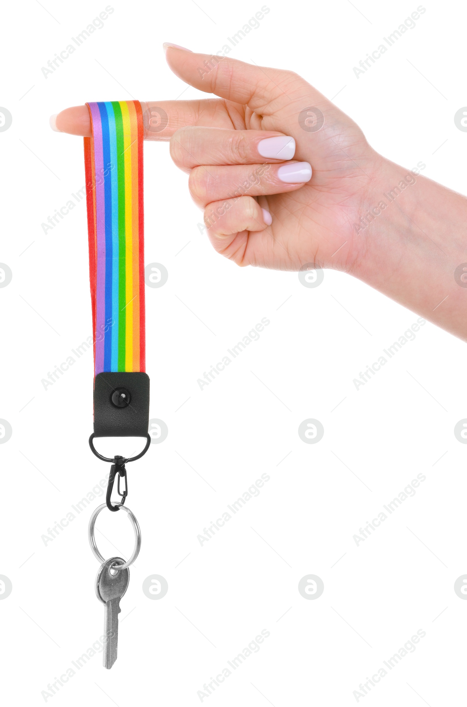 Photo of Woman holding key with keychain in LGBT colors on white background, closeup