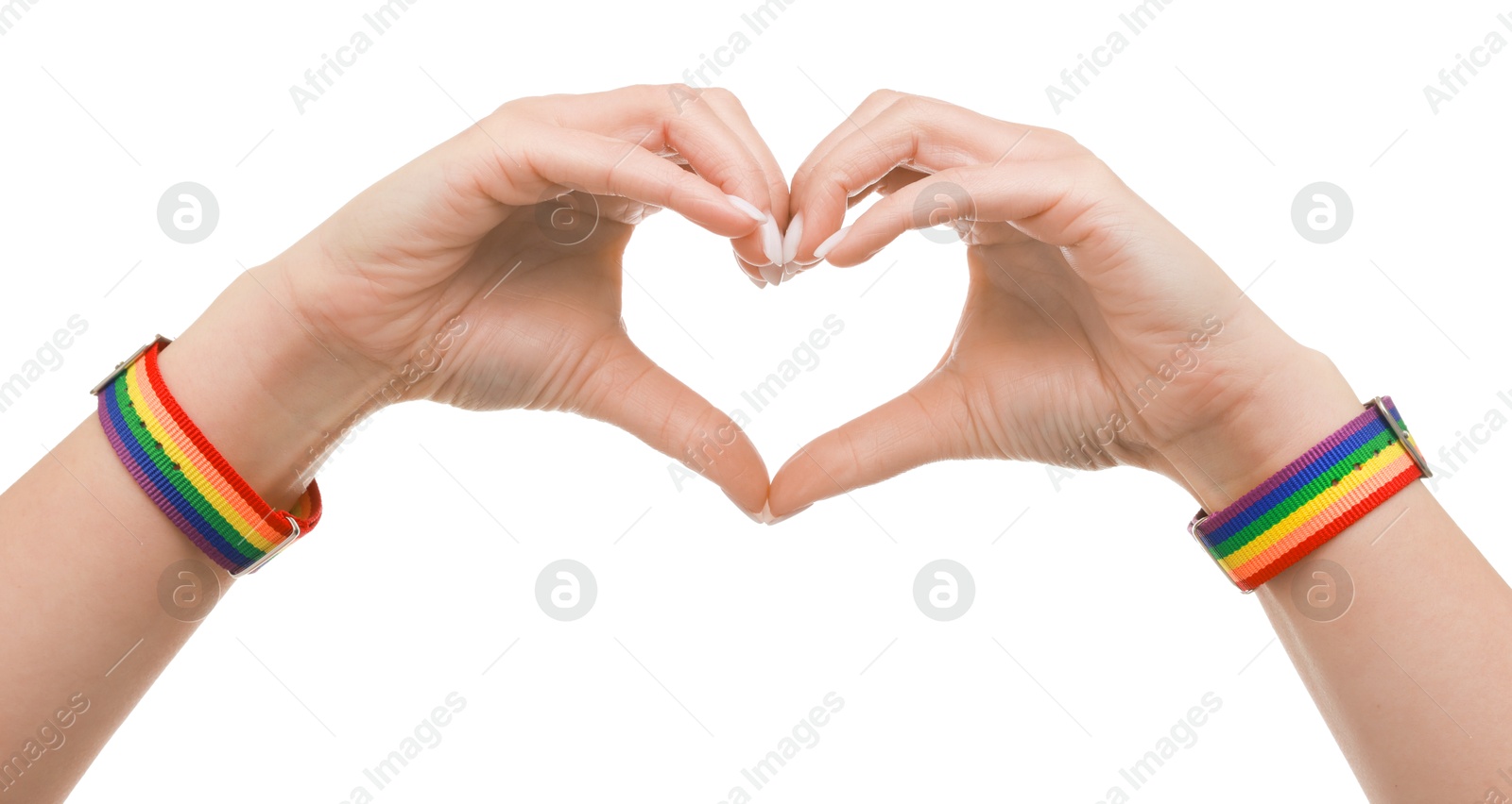 Photo of Woman wearing wristband in LGBT colors and making heart gesture on white background, closeup