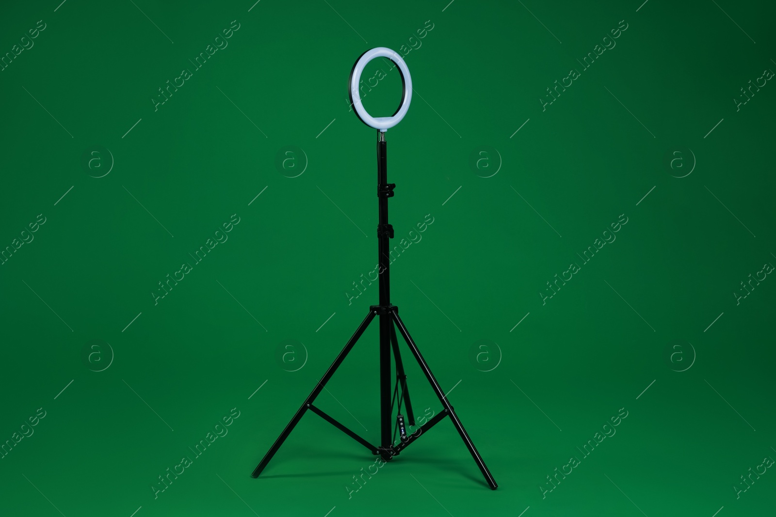 Photo of Ring lamp on stand against green background