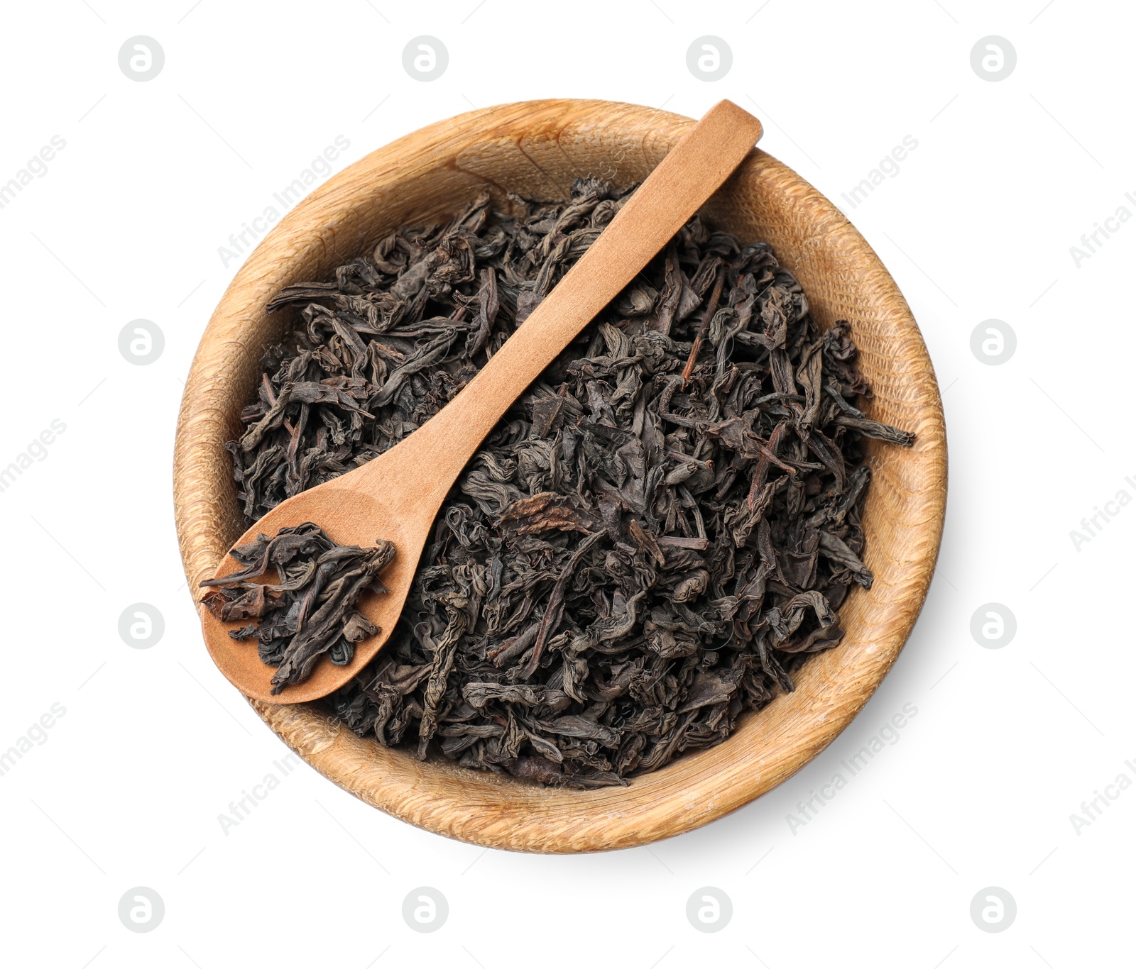 Photo of Dry tea leaves in bowl and spoon isolated on white, top view