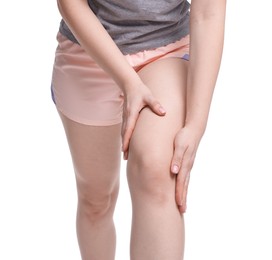 Photo of Young woman suffering from pain in knee on white background, closeup