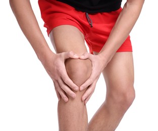 Photo of Young man suffering from pain in knee on white background, closeup