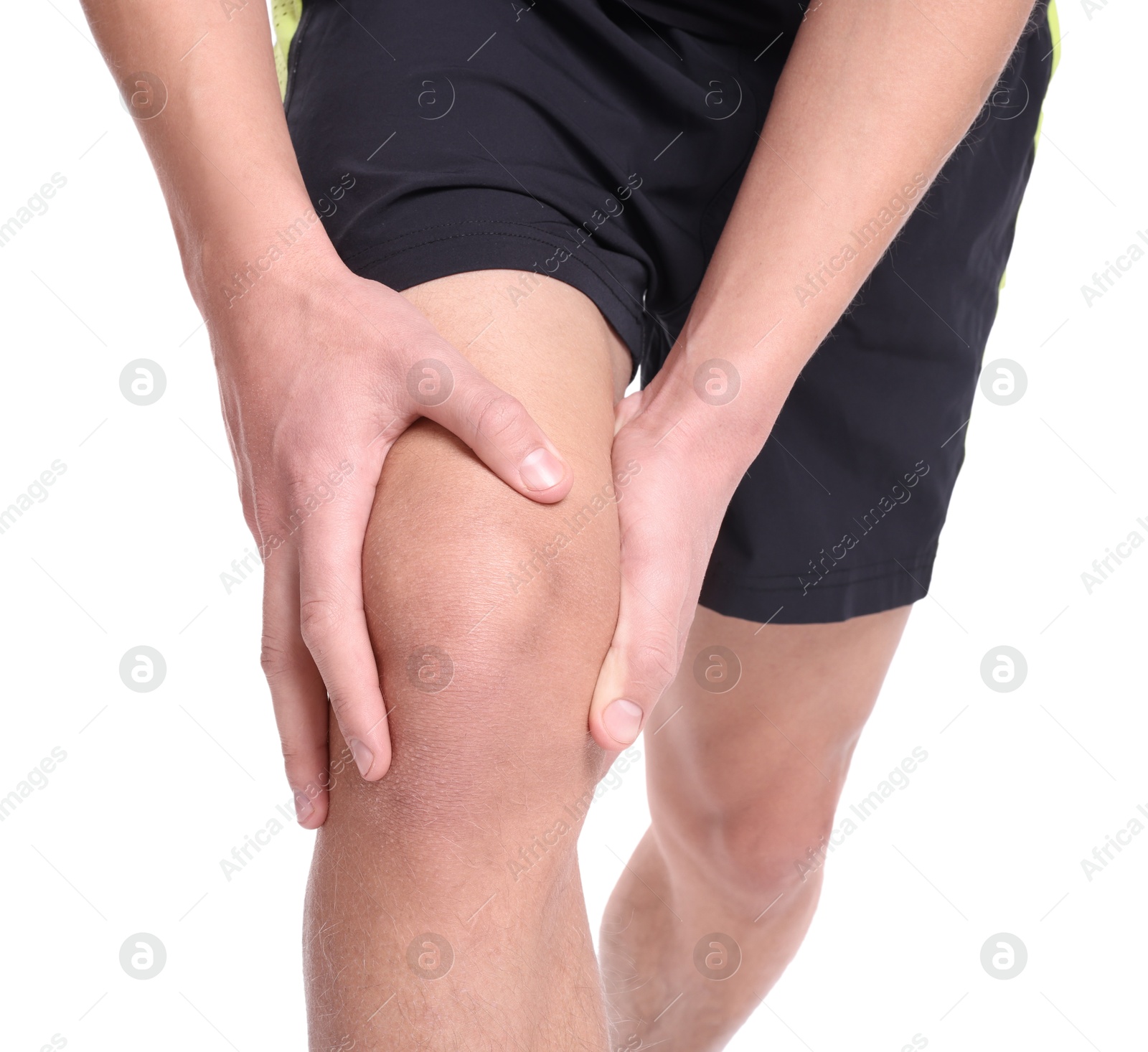 Photo of Young man suffering from pain in knee on white background, closeup