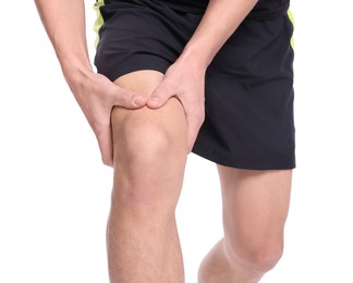 Photo of Young man suffering from pain in knee on white background, closeup