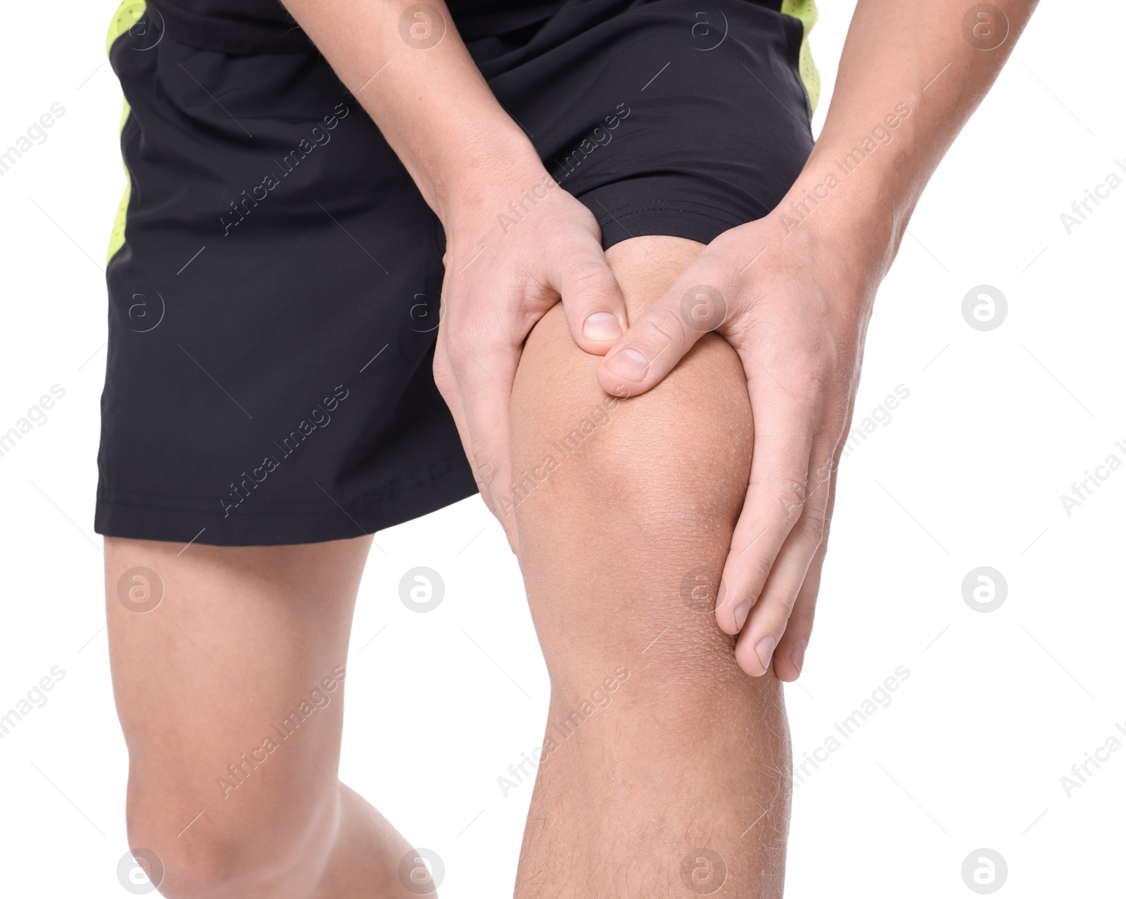 Photo of Young man suffering from pain in knee on white background, closeup