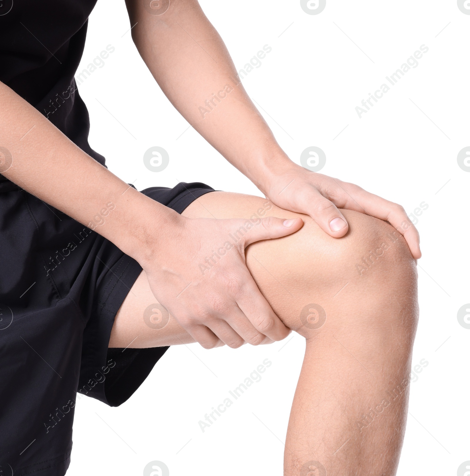 Photo of Young man suffering from pain in knee on white background, closeup