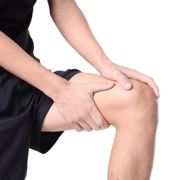 Photo of Young man suffering from pain in knee on white background, closeup