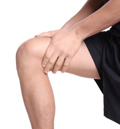 Photo of Young man suffering from pain in knee on white background, closeup