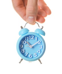 Photo of Man with light blue alarm clock on white background, closeup