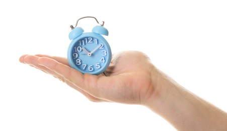 Man with light blue alarm clock on white background, closeup