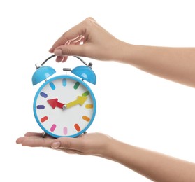 Photo of Woman with alarm clock on white background, closeup