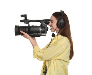 Happy woman with professional video camera and headset on white background