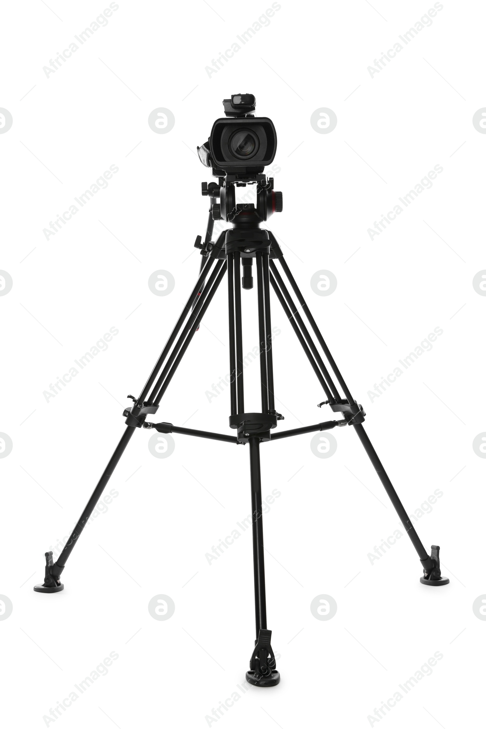 Photo of Modern video camera with tripod isolated on white