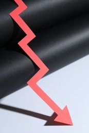 Photo of One red paper arrow on color background, closeup