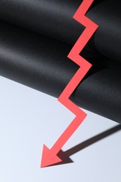 Photo of One red paper arrow on color background, closeup