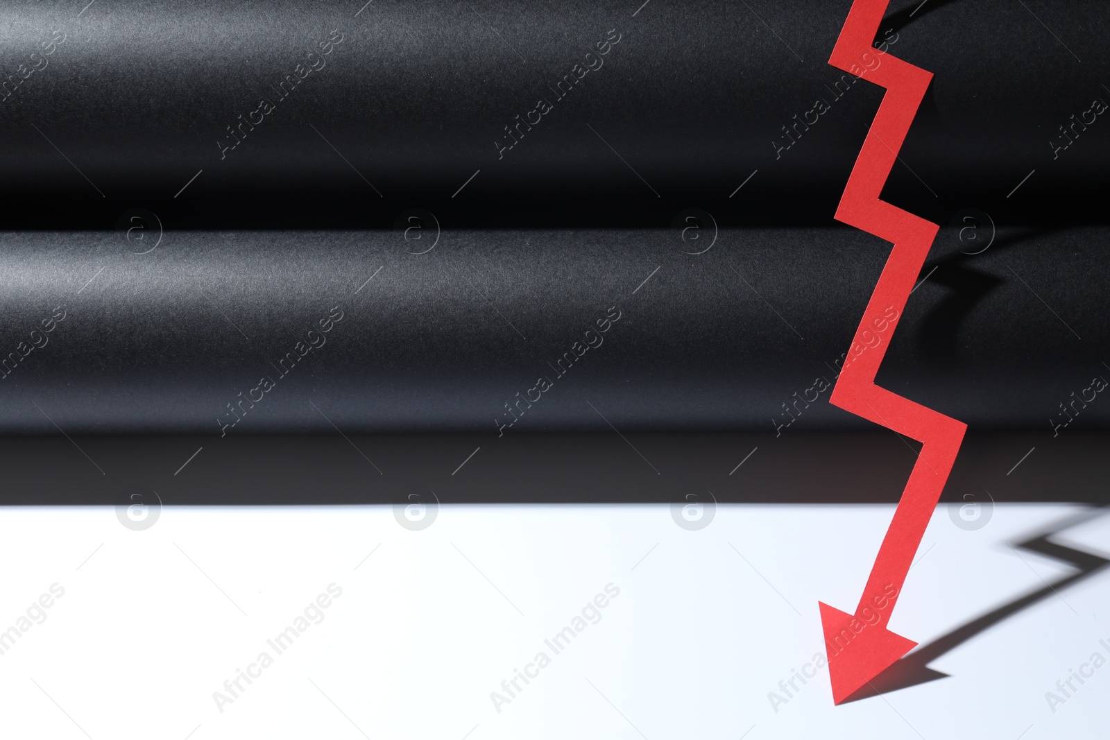 Photo of One red paper arrow on color background, closeup. Space for text