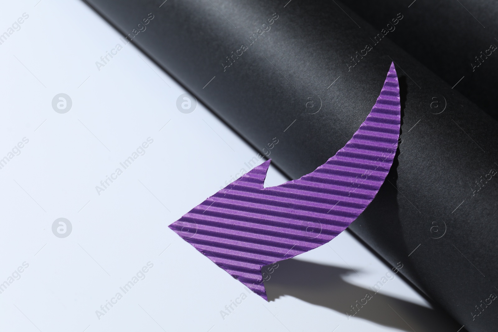 Photo of One purple paper arrow on color background, closeup. Space for text