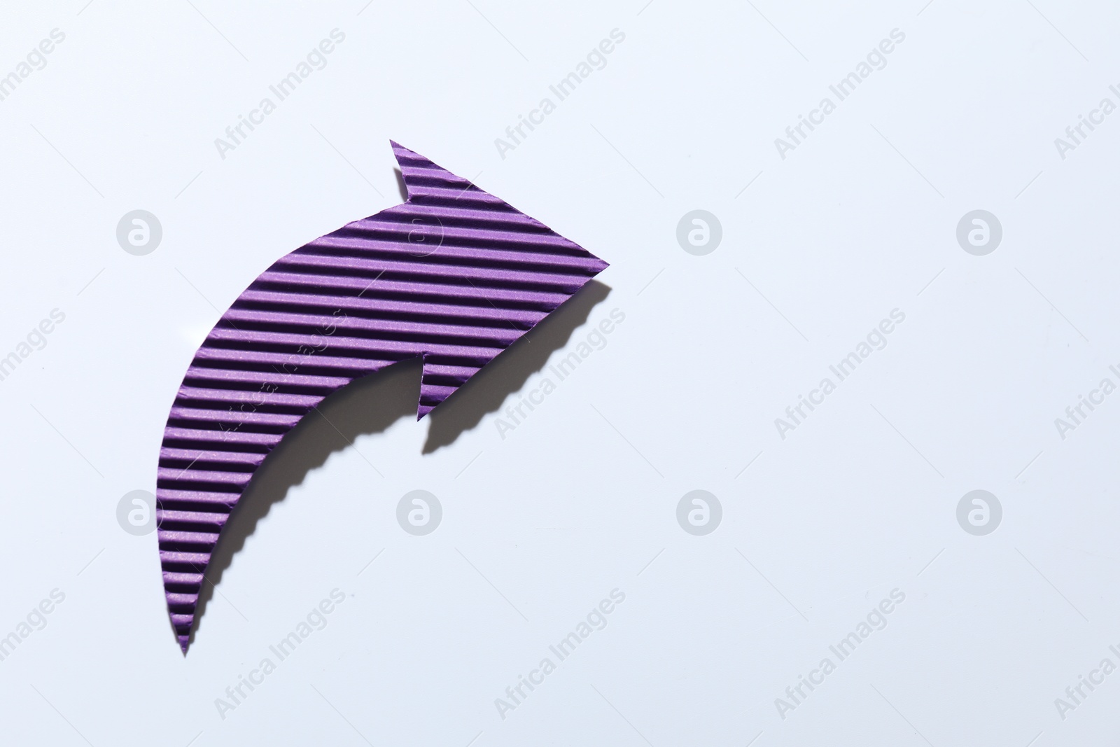 Photo of One purple paper arrow on white background, top view. Space for text