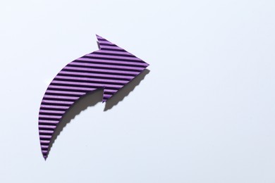 Photo of One purple paper arrow on white background, top view. Space for text