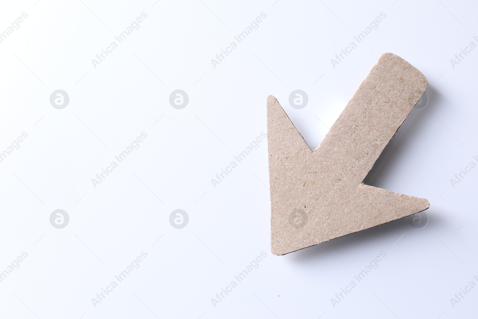 Photo of One kraft paper arrow on white background, top view. Space for text