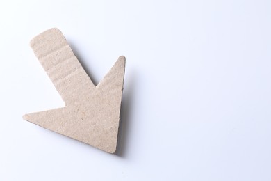 Photo of One kraft paper arrow on white background, top view. Space for text