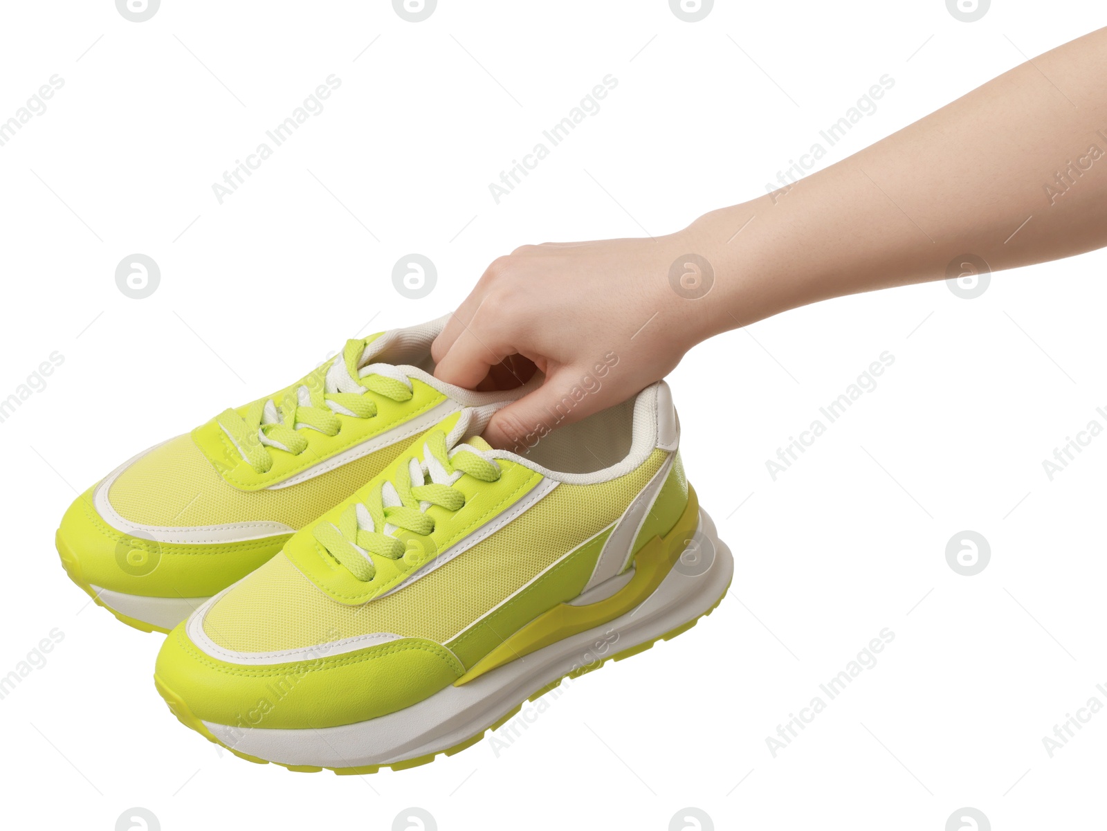 Photo of Woman with neon lime sneakers on white background, closeup