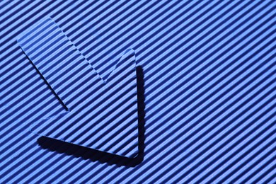 Photo of One paper arrow on blue background, top view. Space for text