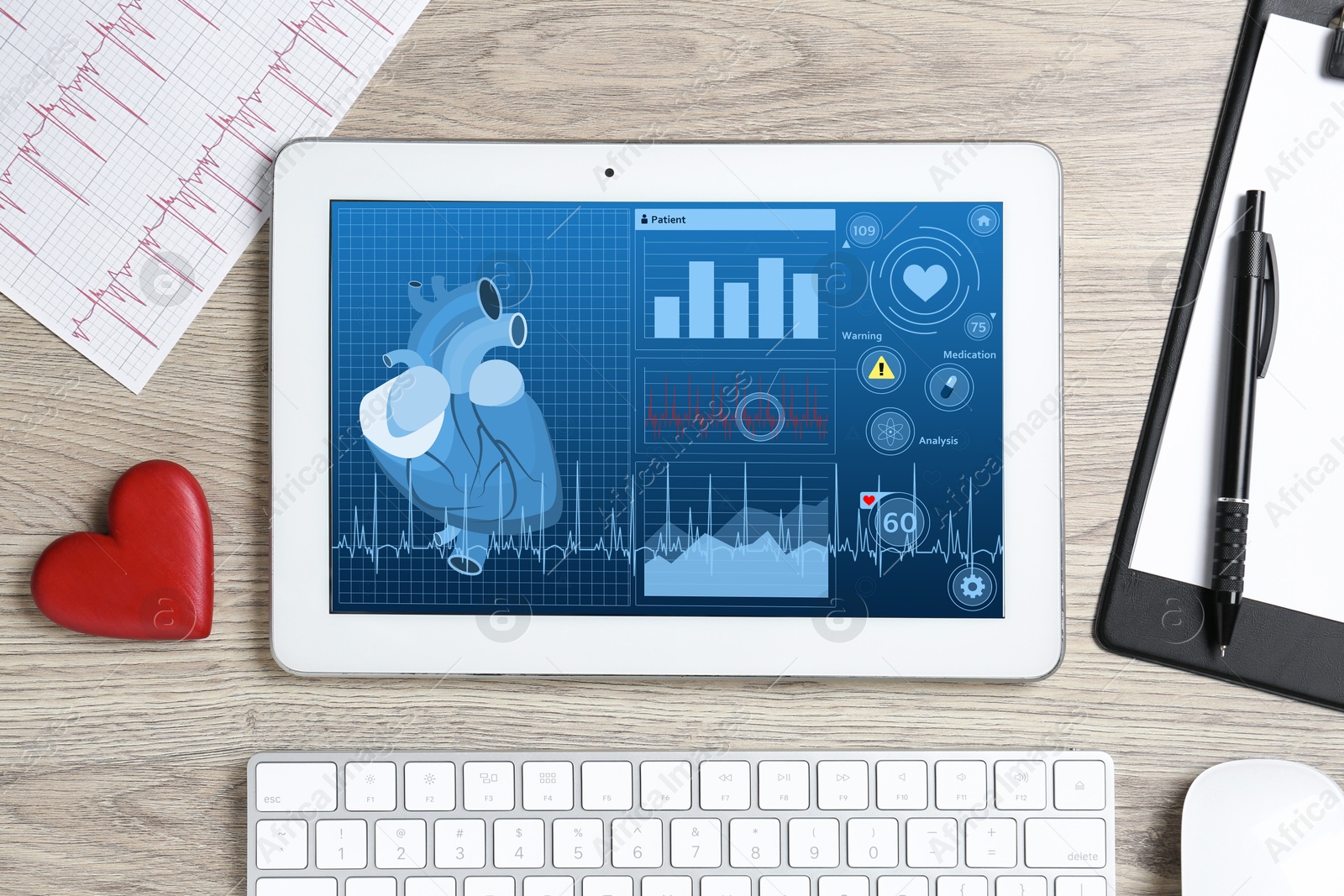 Image of Cardiology. Doctor's workplace with tablet computer on wooden table, top view. Data on device screen